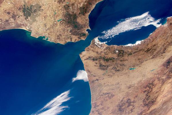 Strait means "narrow", such as when connecting two large bodies of water. Satellite image of the Strait of Gibraltar via Wikimedia Commons