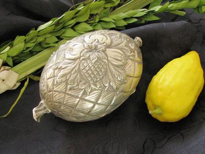 Etrog, silver etrog box and lulav, used on the Jewish holiday of Sukkot. Photograph by Gilabrand via Wikimedia Commons