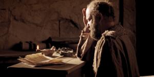 Paul sits in a jail cell, writing an epistle. Image from Bible Videos of The Church of Jesus Christ of Latter-day Saints.