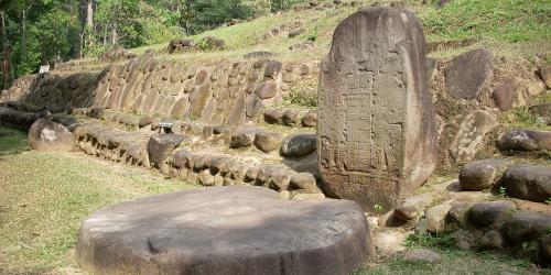 Stela 5 at Takalik Abaj, El Asintal, Retalhuleu, Guatemala, showing an early example of a Long Count date. Altar 8 lies before it. Image via wikimedia Commons